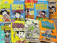Photo showing nine James Patterson Middle School series books with colorful covers and titles including Dog's Best Friend, Get Me Out of Here!, Ultimate Showdown, Master of Disaster, Funny, From Hero to Zero, Big Fat Liar, Escape to Australia, and Broccoli and Snake Hill.