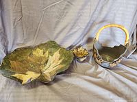 Photo showing large green and yellow leaf wall hanging with two decorative baskets.