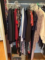 Closet rod with hanging women's dresses and skirts in various colors and styles