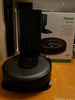 Robot vacuum and Clean Base station displayed in front of product box