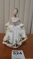Front view of the Royal Doulton Country Rose figurine, showing detailed floral dress and delicate facial features.