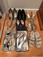 Full overview of nine pairs of women's shoes including metallic silver Kalenas heels, black, beige and patterned sandals and dress shoes.