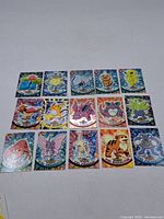 Full view displaying 17 assorted Pokemon trading cards with colorful backgrounds and character illustrations from the 1990s-2000s era.