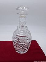 Full view of the heavy crystal decanter showing intricate cut glass pattern on the body and stopper.