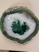Close-up of the first stone geode coaster showing crystalline quartz center with green outer band and rough edges