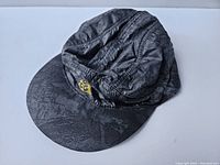 Black Nike ACG hat laid flat showing overall shape and pattern.