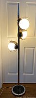 Full front view of lamp illuminated against door background