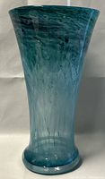 Front view of tall blue-green blown glass vase showing tapered shape and color pattern