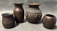 All four pottery pieces arranged front-on