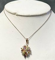 Front view of the necklace displayed on bust showing multi-colored crystal pendant