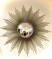 Front view of the large sunburst mirror showing convex beveled glass and nickel metal rays