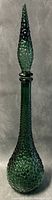 Full view of the 22-inch tall emerald green Empoli glass genie bottle with bubble pattern and pointed lid.