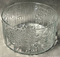 Clear glass Flora serving bowl by Iittala with embossed floral patterns shown from an angle.