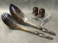 Photo showing the pair of vintage hammered silver plated salad servers with detailed human figure handles.