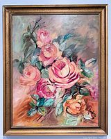Frontal view of the floral still life painting capturing pink and peach roses with green leaves, signed by E Hinding dated 1964, showing the frame and colors clearly.