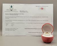 Appraisal certificate and ring in apple-shaped box