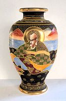 Front side view of the large Japanese satsuma style vase showing the hand-painted seated figure and repeating scenic elements with gold accents.