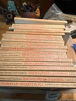Stacked view of 20 Better Homes and Gardens Encyclopedia of Cooking books, showing spines with volume numbering from 1 to 20.