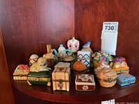 Multiple hinged trinket boxes of various shapes including animals, fruit, floral, and novelty.