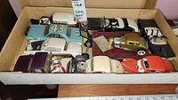 Photo showing a variety of vintage and antique model cars including the blue Richard Petty race car #43 and several other classic models in a box.