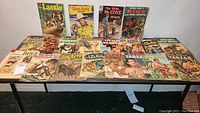Full table view showing all 18 vintage Dell Comics comics included in the lot with a variety of cover art styles and characters.