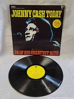 Vinyl record outside the cover showcasing the yellow label with album title and artist information.