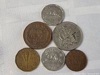 Top view of the 6 coins showing various designs including coat of arms, beaver, and maple leaves.
