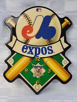 Full view of vintage Montreal Expos baseball wall clock with team logo, baseball bats, and baseball showing clock face