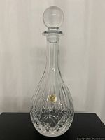 Front view of the RCR crystal wine decanter with the stopper in place, showing the teardrop shape and diamond-cut pattern.