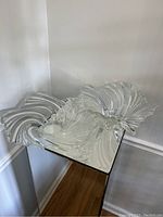 Two Mikasa crystal bowls placed on a mirrored surface showing the swirling designs and clear crystal material.