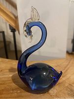 Side view of the vintage Murano glass swan showing the curved neck and clear glass head detail