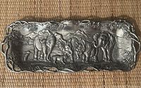 Top-down view of the rectangular silver platter showing detailed safari scene with elephants, rhino and birds, with leafy vine edge and integrated handles.
