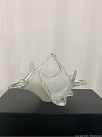 Front angled view of the vintage Murano glass basket highlighting its clear and white glass and sculptural form.