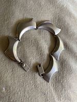 Photo showing the full length of the sterling silver bracelet laid out flat with the clasp open.