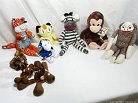 Photo of entire collection showing all stuffed animals arranged in group on white background