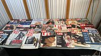 Overall lot overview with multiple Life magazines spread out on table, showcasing varied covers from different eras featuring people, events, and cultural imagery.