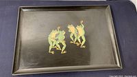 Black rectangular serving tray with colorful dancing frogs inlay in center.