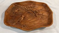 Top-down image of the entire composite bird dish showing the birds on branches and pinecone design.