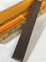 Close-up image of the copper cased ruler placed in its decorative box showing the ruler dimensions and casing.
