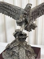 Close-up front view of the detailed eagle sculpture showing the textured feathers and dynamic pose.