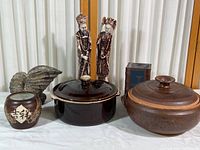Overall lot showing two figurines, two casseroles, two small vases, and shell sculpture.