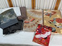 Photo showing all kimono and fabric pieces laid out including two packaged obi sashes and several folded fabric items