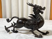 Side view of dragon figurine showing full body profile