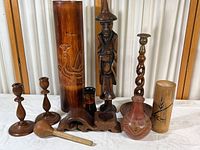 Full view of woodware collection featuring bamboo vase, carved standing man, candlesticks, vessels, pot and scoop