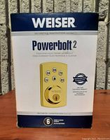 Front of box showing Weiser Powerbolt 2 branding and lock image, states 6 user codes and lifetime warranty on electronic components.