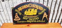 Full front view of the vintage wooden advertising sign with Rigden Stroud branding and sailing ship illustration.