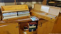 Two pine wood storage boxes open, showing placement of plastic organizers