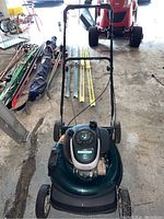 Full view of the Mastercraft lawnmower showing the green deck, handlebar, and wheels.