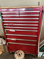 Full front view of red tool chest showing all 12 drawers and castors
