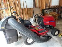 Side view of red Toro LX423 riding mower with bag assembly attached